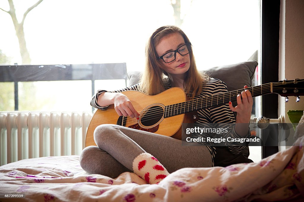 Teen girl playing guitar