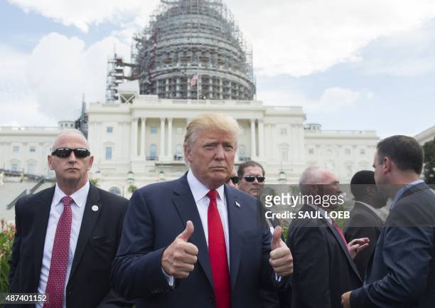 Republican Presidential hopeful Donald Trump gives a thumbs-up as he arrives for a Tea Party rally against the international nuclear agreement with...