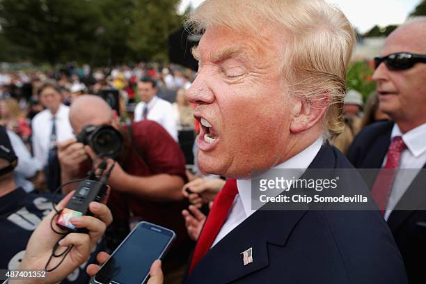 Republican presidential candidate Donald Trump talks with journalists during a rally against the Iran nuclear deal on the West Lawn of the U.S....