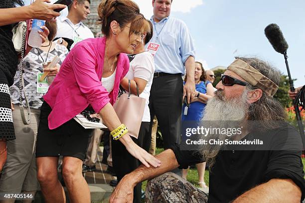 Reality television personality Phil Robertson and Sarah Palin visit during a rally against the Iran nuclear deal on the West Lawn of the U.S. Capitol...