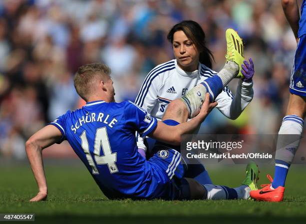 Andre Schurrle of Chelsea receives treatment from Chelsea physio Eva Carneiro during the Barclays Premier League match between Liverpool and Chelsea...