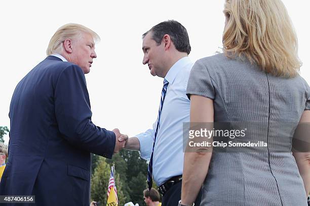 Republican presidential candidates Donald Trump and Sen. Ted Cruz and his wife Heidi Nelson Cruz meet on stage during a rally against the Iran...