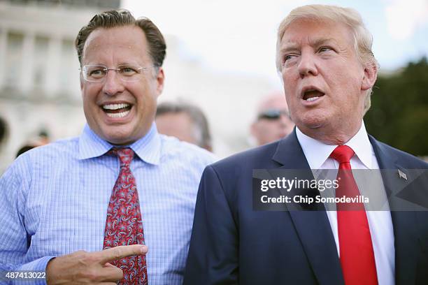 Rep. Dave Brat reacts as Republican presidential candidate Donald Trump says it would be 'the end of his political career' if Brat does not support...