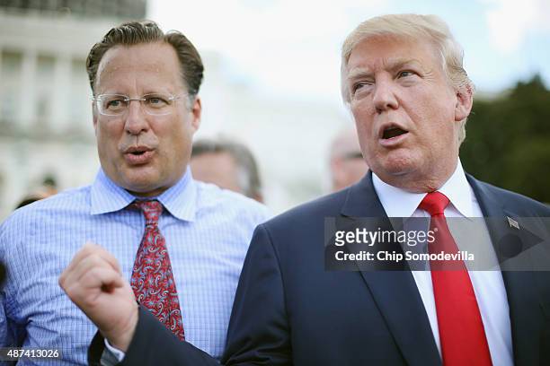 Rep. Dave Brat reacts as Republican presidential candidate Donald Trump says it would be 'the end of his political career' if Brat does not support...