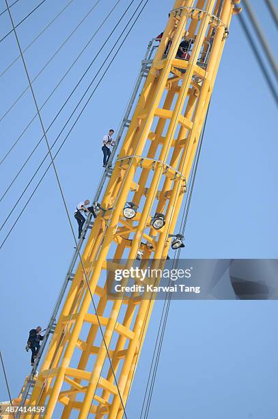 Sam Branson and Noah Devereux scale the 02 Arena during a photocall to launch the Virgin STRIVE Challenge held at the 02 Arena on April 30, 2014 in...