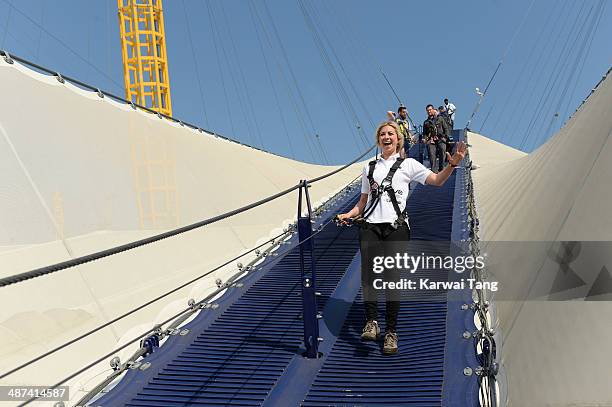 Holly Branson scales the 02 Arena during a photocall to launch the Virgin STRIVE Challenge held at the 02 Arena on April 30, 2014 in London, England.