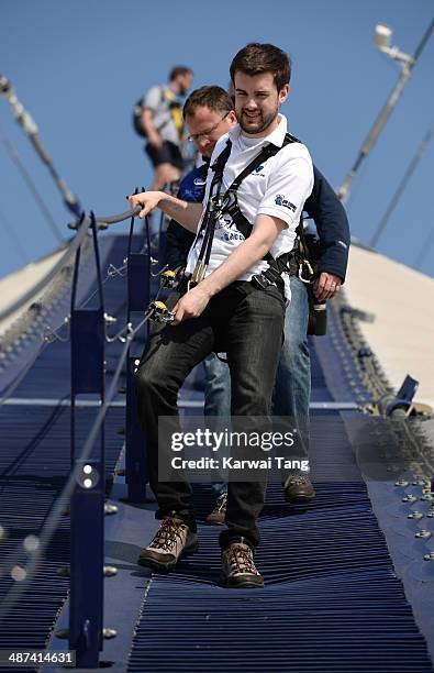 Jack Whitehall scales the 02 Arena during a photocall to launch the Virgin STRIVE Challenge held at the 02 Arena on April 30, 2014 in London, England.