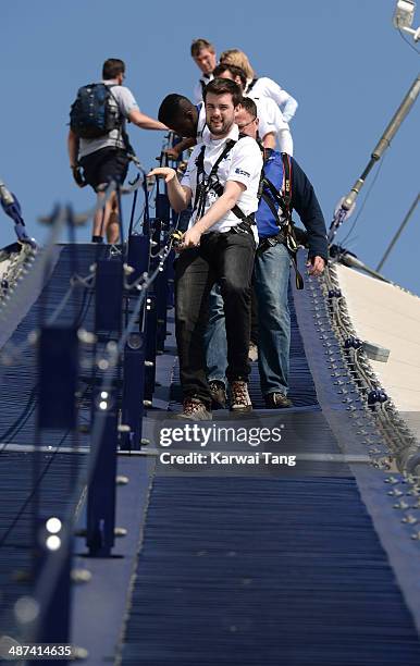 Jack Whitehall scales the 02 Arena during a photocall to launch the Virgin STRIVE Challenge held at the 02 Arena on April 30, 2014 in London, England.