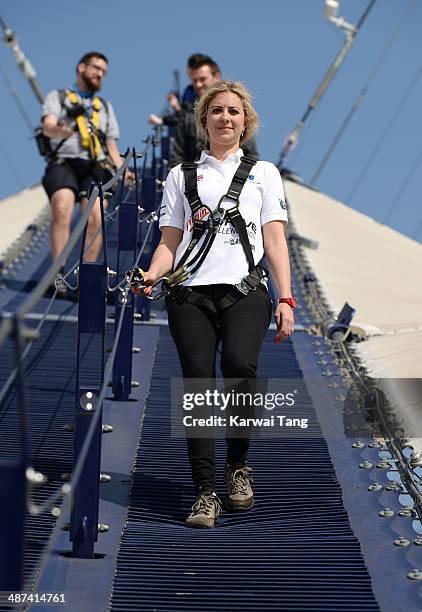 Holly Branson scales the 02 Arena during a photocall to launch the Virgin STRIVE Challenge held at the 02 Arena on April 30, 2014 in London, England.