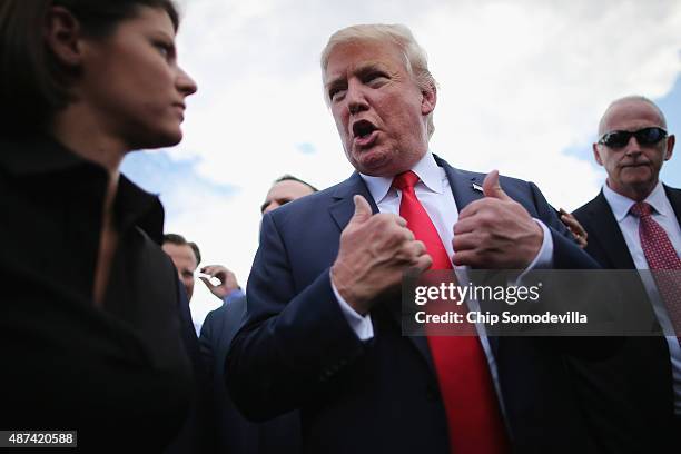 Republican presidential candidate Donald Trump talks with journalists during a rally against the Iran nuclear deal on the West Lawn of the U.S....