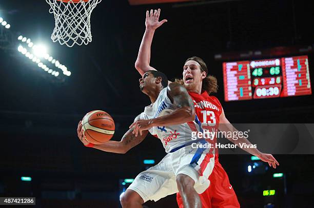 Edgar Sosa of Dominican Republic goes for a layup against Kelly Olynyk of Canada during a second stage match between Dominican Republic and Canada as...