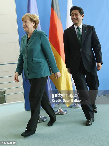 German Chancellor Angela Merkel and Japanese Prime Minister Shinzo Abe depart after speaking to the media following talks at the Chancellery on April...