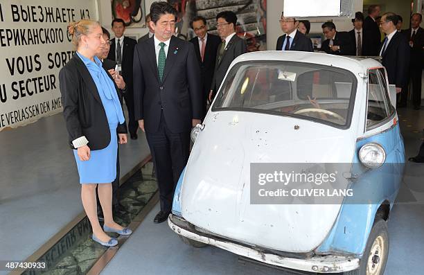 Japanese Prime Minister Shinzo Abe is shown around the Wall Museum at Checkpoint Charlie by museum's director Alexandra Hildebrandt in Berlin on...