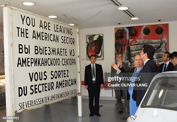 Japanese Prime Minister Shinzo Abe is shown around the Wall Museum at Checkpoint Charlie by museum's director Alexandra Hildebrandt in Berlin on...