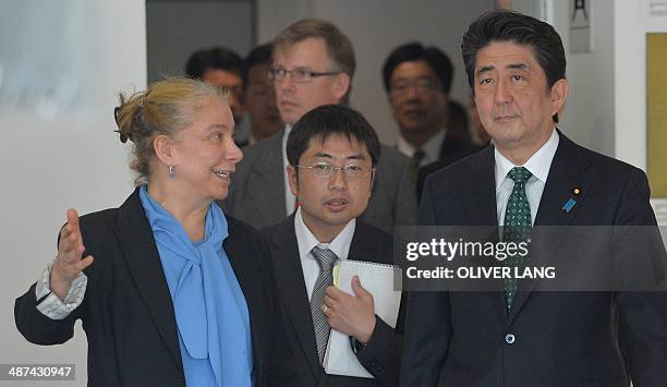 Japanese Prime Minister Shinzo Abe is shown around the Wall Museum at Checkpoint Charlie by museum's director Alexandra Hildebrandt in Berlin on...