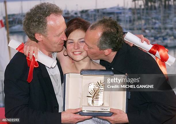 Belgian directors Luc and Jean-Pierre Dardenne pose with Belgian actress Emilie Dequenne and the Palme d'or of the 52nd Cannes Film Festival they...
