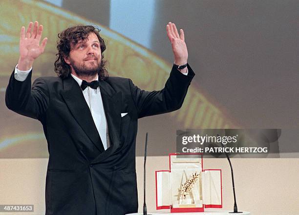 Yugoslav director Emir Kusturica waves to the public after he was awarded the Golden Palm for his movie "Underground" 28 May 1995 at the 48th Cannes...