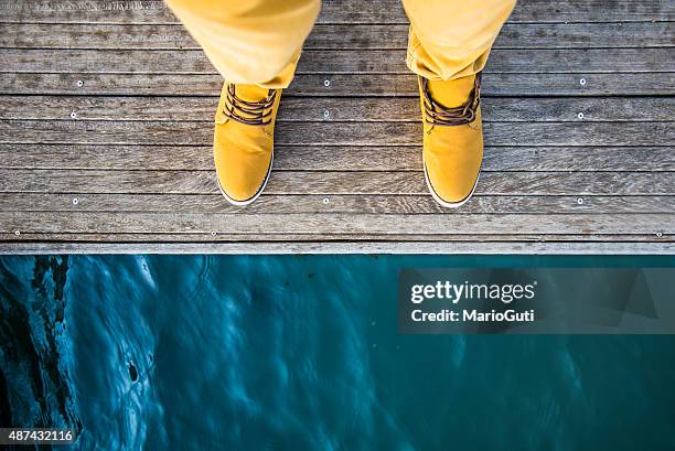 man by the lake - boots over pants stock pictures, royalty-free photos & images