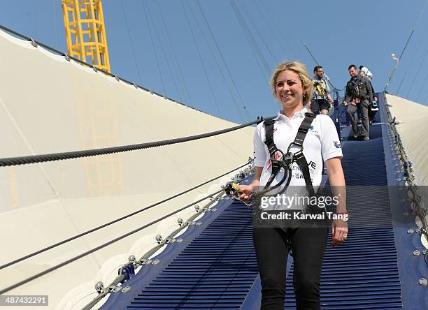 Holly Branson scales the 02 Arena during a photocall to launch the Virgin STRIVE Challenge held at the 02 Arena on April 30, 2014 in London, England.