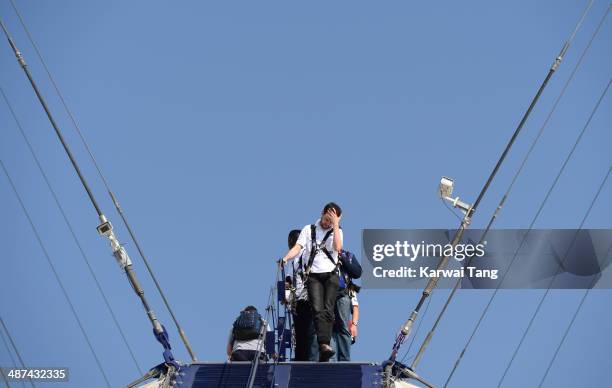 Jack Whitehall scales the 02 Arena during a photocall to launch the Virgin STRIVE Challenge held at the 02 Arena on April 30, 2014 in London, England.