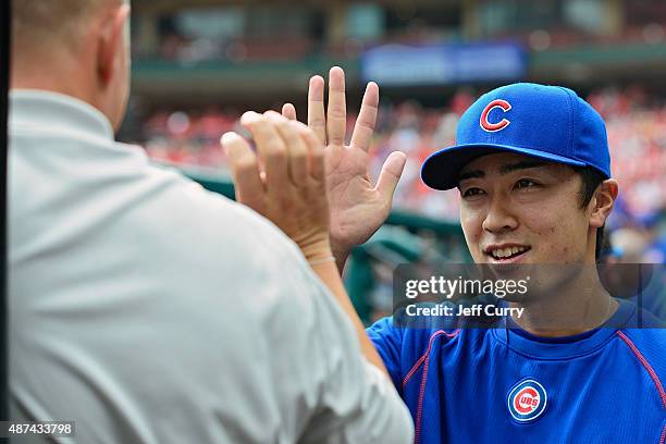 Tsuyoshi Wada of the Chicago Cubs high fives a trainer before a game against the St. Louis Cardinals at Busch Stadium on September 9, 2015 in St....