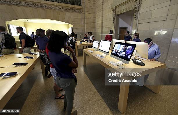 People watch Apple's announcement of new versions of old products at a Apple Store in New York, NY on September 9, 2015. Apple Inc. Unveils iPhone...