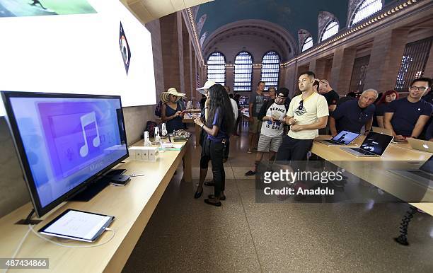 People watch Apple's announcement of new versions of old products at a Apple Store in New York, NY on September 9, 2015. Apple Inc. Unveils iPhone...