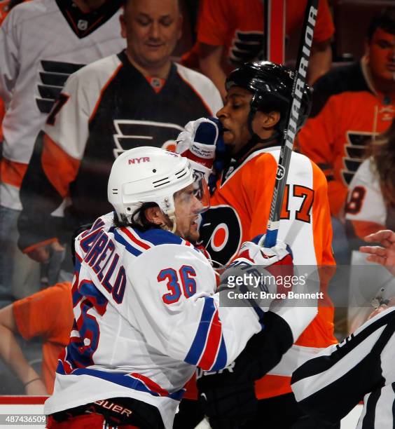 Mats Zuccarello of the New York Rangers gets the glove up on Wayne Simmonds of the Philadelphia Flyers in Game Six of the First Round of the 2014 NHL...