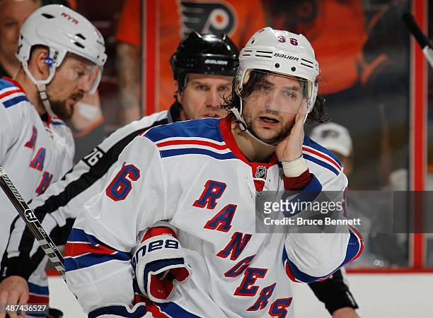 Mats Zuccarello of the New York Rangers leaves the ice after being hit by Wayne Simmonds of the Philadelphia Flyers after scoring in the closing...