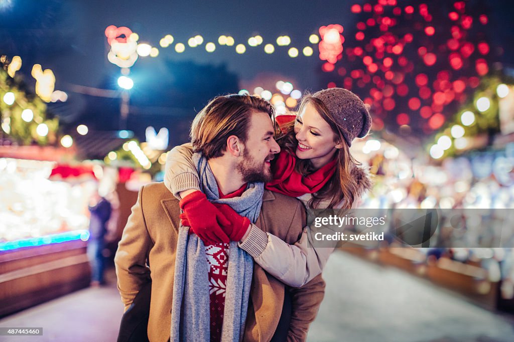 Couple having fun outdoors at winter fair.