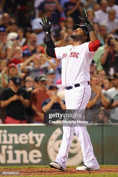 David Ortiz of the Boston Red Sox celebrates after hitting his 498th career home run during the third inning against the Toronto Blue Jays at Fenway...