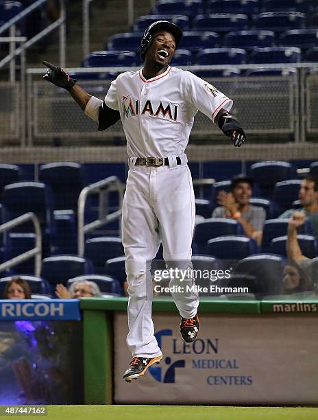 Dee Gordon of the Miami Marlins celebrates after scoring during a a game against the Milwaukee Brewers at Marlins Park on September 9, 2015 in Miami,...