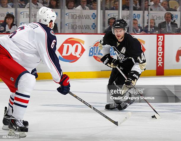 Chris Kunitz of the Pittsburgh Penguins moves the puck in front of Nikita Nikitin of the Columbus Blue Jackets in Game Five of the First Round of the...