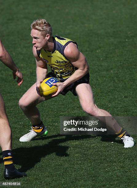 Steven Morris of the Tigers runs with the ball during a Richmond Tigers AFL training session at ME Bank Centre on September 10, 2015 in Melbourne,...