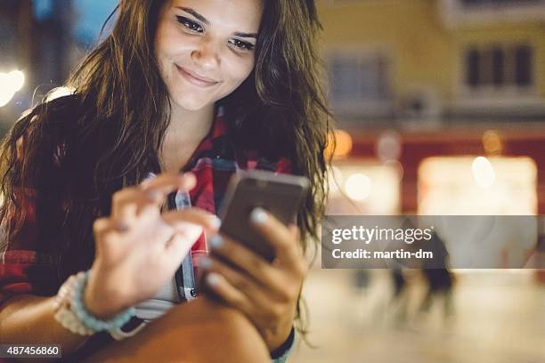 girl texting on smartphone outside - girls on mobile stock pictures, royalty-free photos & images