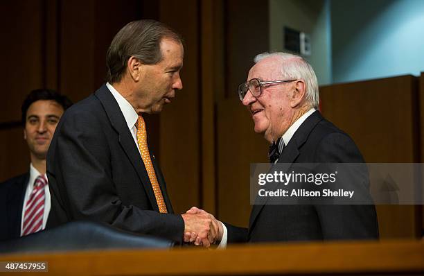 Former Supreme Court Justice John Paul Stevens talks with U.S. Sen. Mark Udall after testifying before the Senate Committee on Campaign Finance on...