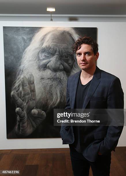 Artist, Vincent Fantauzzo poses in front of his portrait 'Kudditji' on September 10, 2015 in Sydney, Australia.