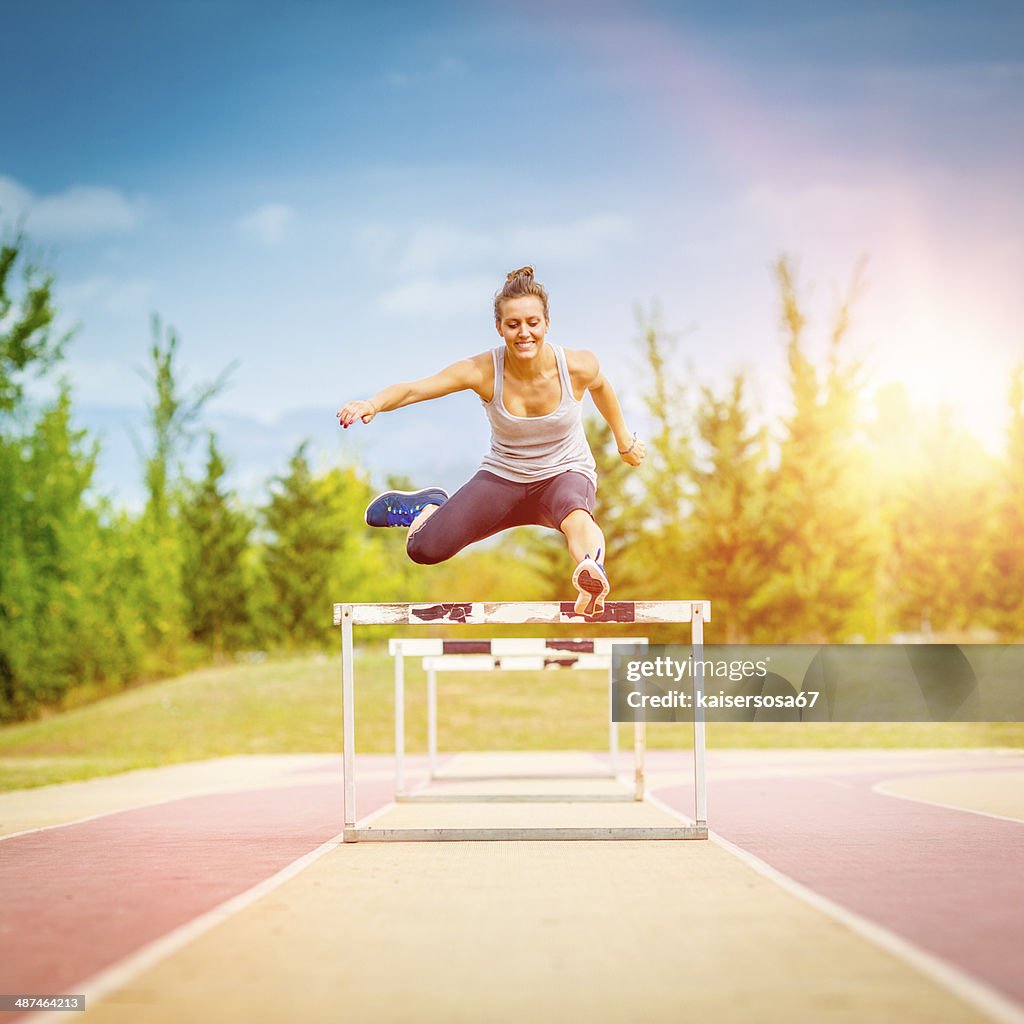 Female competitor jumping the steeplechase obstacle