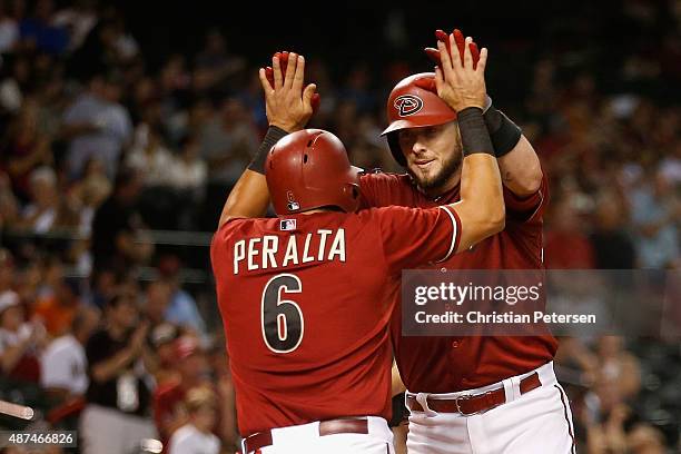 Jarrod Saltalamacchia of the Arizona Diamondbacks high-fives David Peralta after hitting a two-run home run against the San Francisco Giants during...