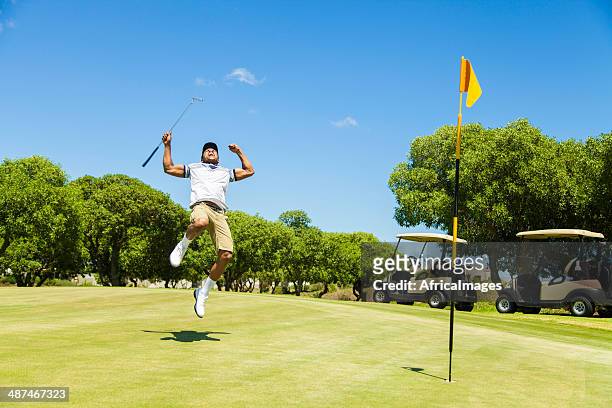 african golfer celebrating sinking his putt! - golfer stock pictures, royalty-free photos & images