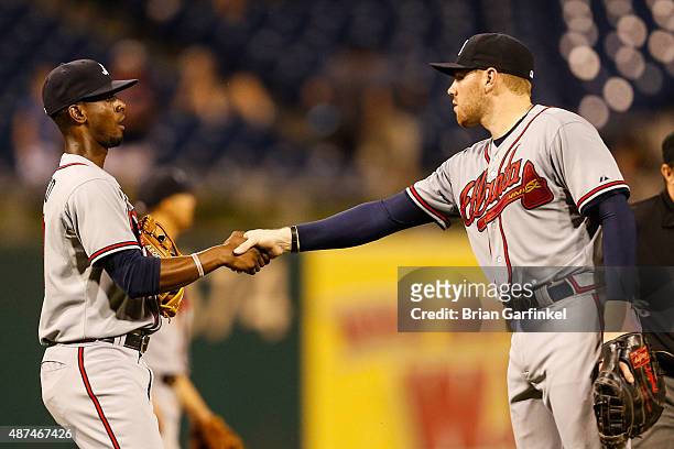 Pedro Ciriaco and Freddie Freeman of the Atlanta Braves shake hands after the game against the Philadelphia Phillies at Citizens Bank Park on...