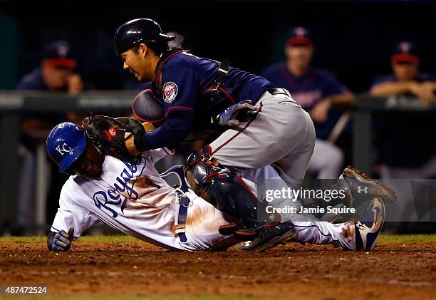 Kurt Suzuki of the Minnesota Twins tags out Jarrod Dyson of the Kansas City Royals at home plate while Dyson tries to score during the 10th inning of...