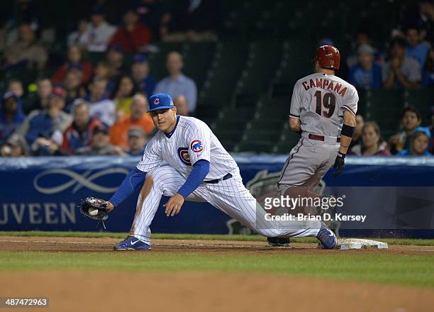 First baseman Anthony Rizzo of the Chicago Cubs catches a ball to retire Tony Campana of the Arizona Diamondbacks during the seventh inning at...