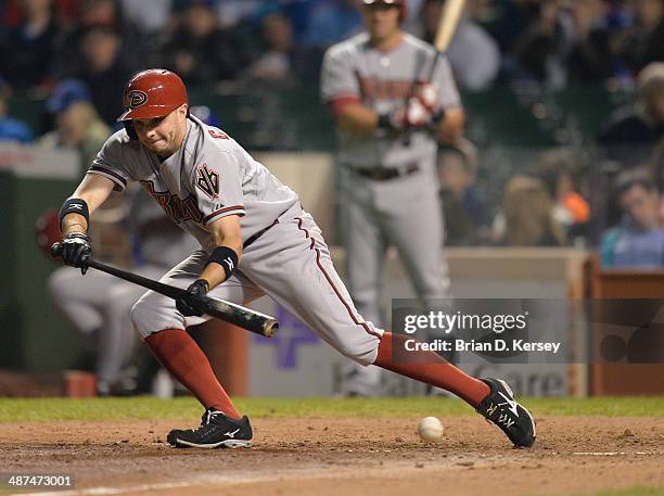 Tony Campana of the Arizona Diamondbacks tries to bunt during the seventh inning against the Chicago Cubs at Wrigley Field on April 21, 2014 in...