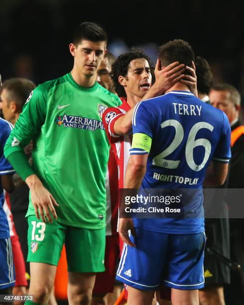 Tiago of Club Atletico de Madrid consoles John Terry of Chelsea as Thibaut Courtois looks on after the UEFA Champions League semi-final second leg...