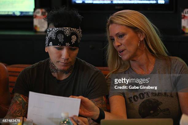 Guitarist Dj Ashba of Sixx:A.M. And Dina Mitchell attend Touchdown for Charity's celebrity fantasy football draft at Born and Raised Tavern/Lounge on...