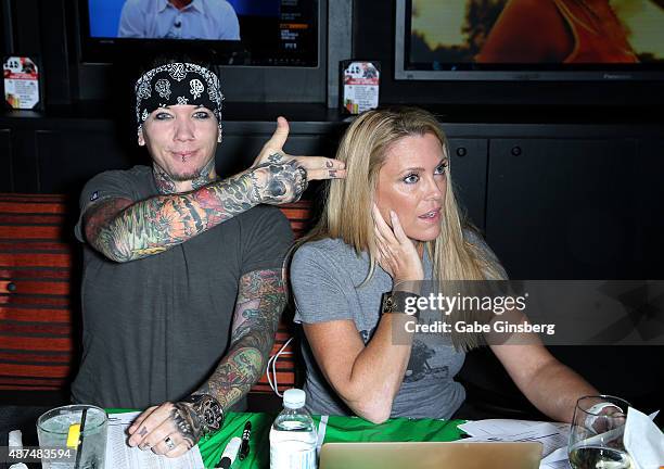 Guitarist Dj Ashba of Sixx:A.M. And Dina Mitchell attend Touchdown for Charity's celebrity fantasy football draft at Born and Raised Tavern/Lounge on...