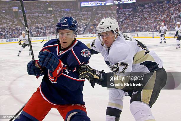 Sidney Crosby of the Pittsburgh Penguins checks Matt Calvert of the Columbus Blue Jackets while chasing after the puck during Game Six of the First...