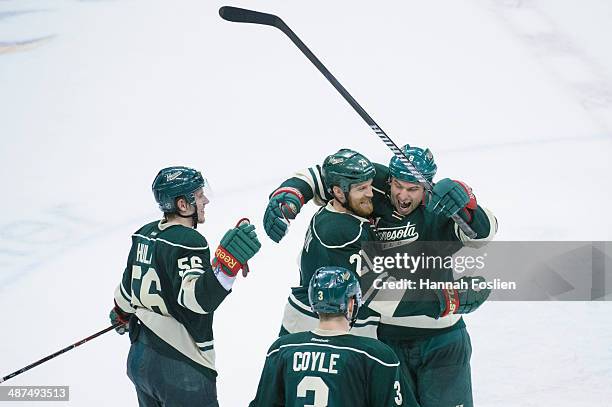 Erik Haula, Charlie Coyle, Kyle Brodziak and Cody McCormick of the Minnesota Wild celebrate a win against the Colorado Avalanche of Game Six of the...
