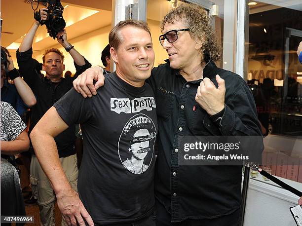 Artist Shepard Fairey and photographer Mick Rock attend the TASCHEN Gallery opening reception for "Mick Rock: Shooting For Stardust - The Rise Of...